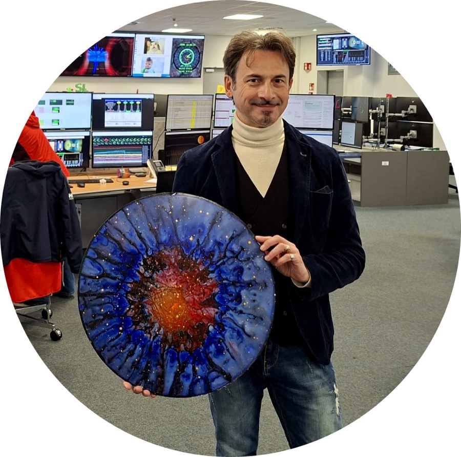Enrico Magnani holding a Supernova Dark Matter painting in the CMS control room
